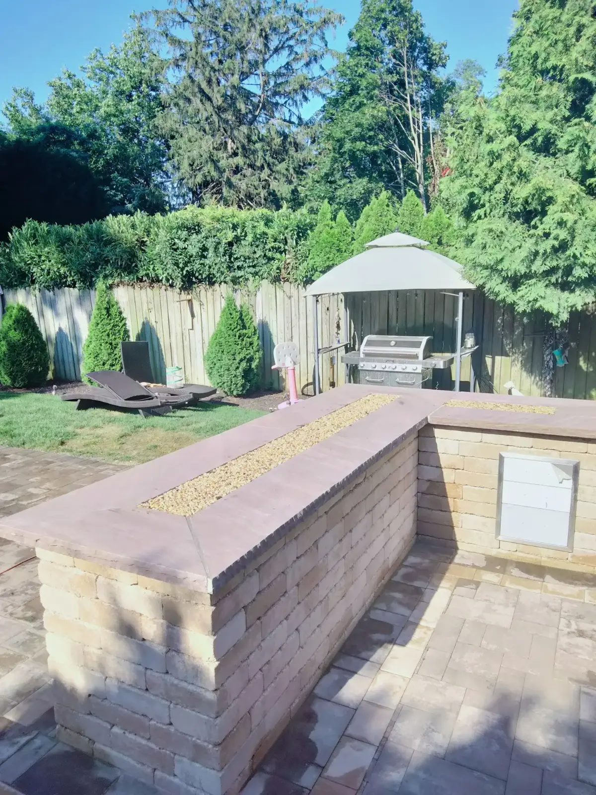 Outdoor bar with stone-capped walls by Promaster Maintenance Corp, Long Island, NY