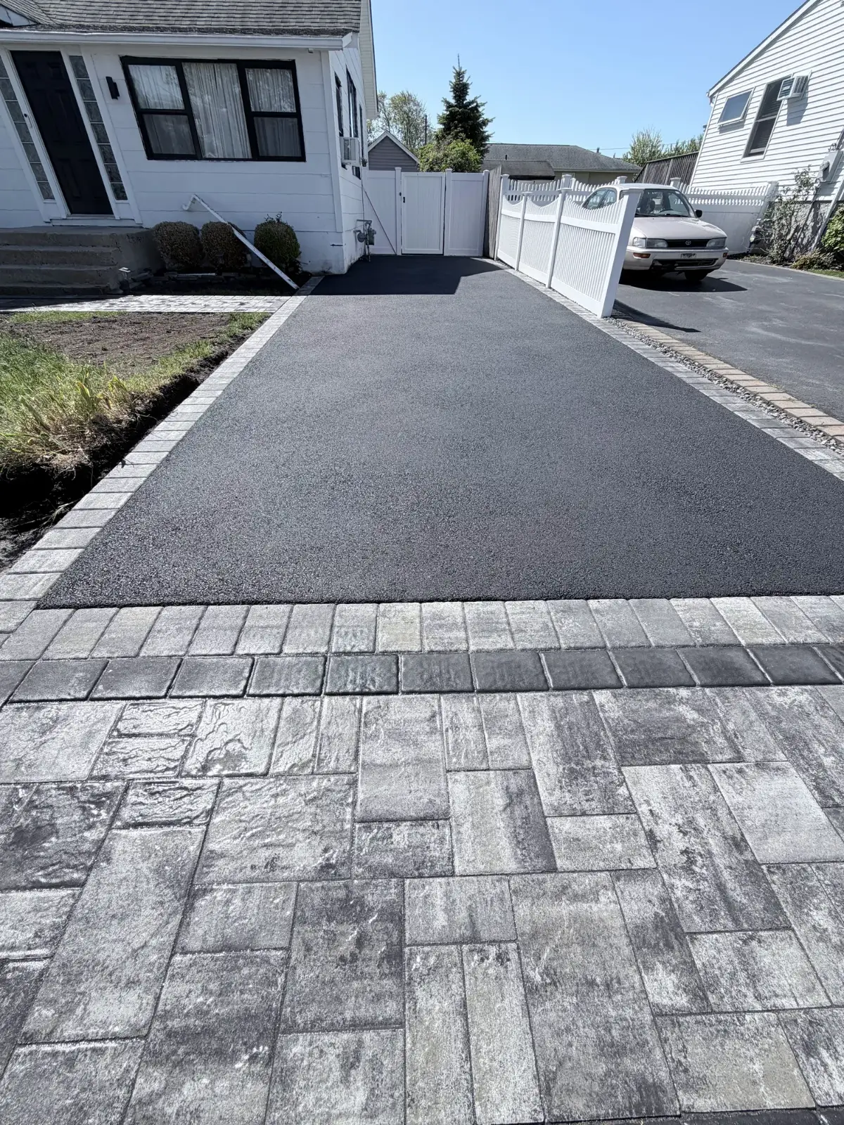 Asphalt driveway with paver border by Promaster Maintenance Corp, Long Island, NY