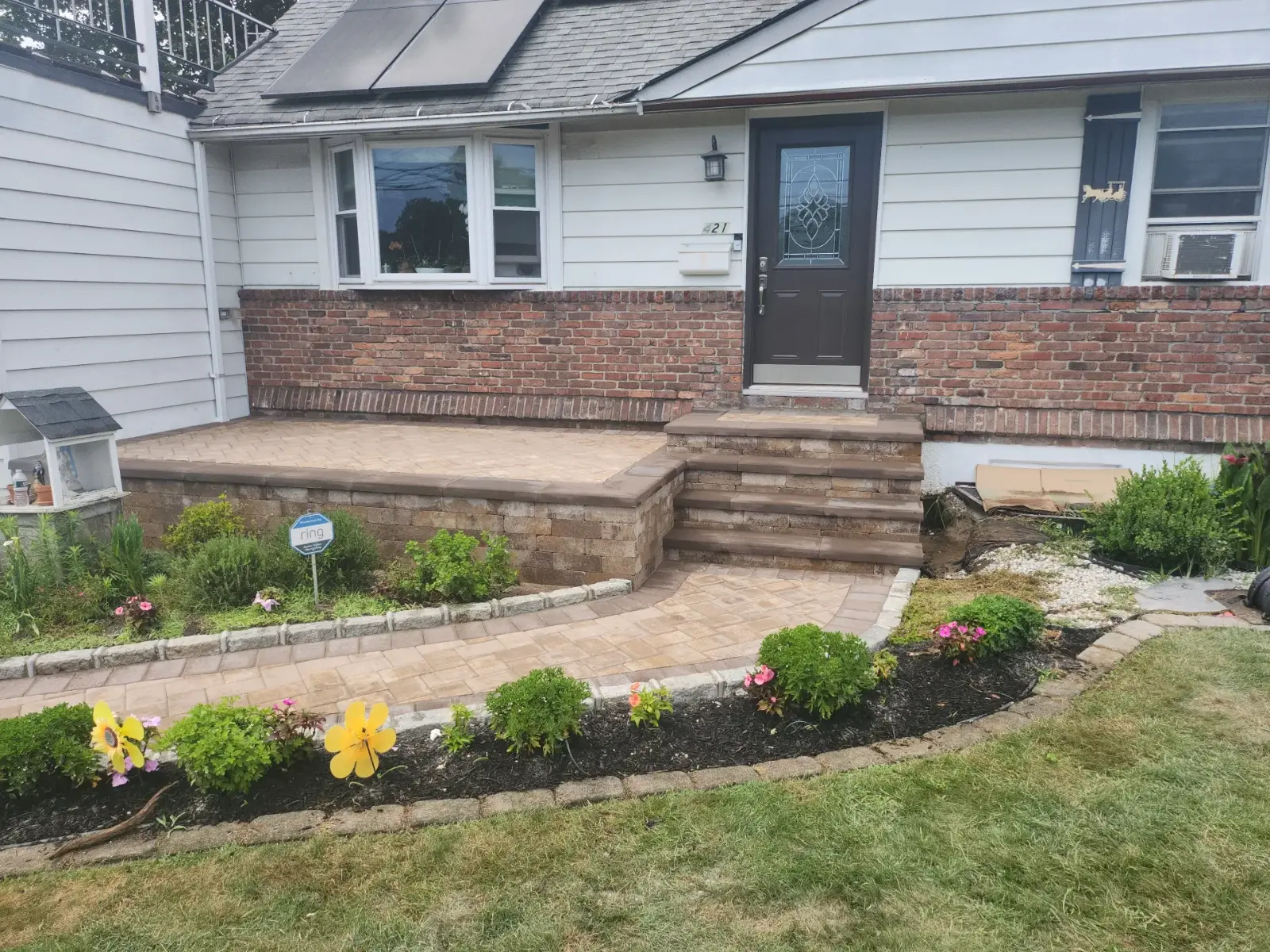 Raised paver porch, steps and walkway by Promaster Maintenance Corp on a Long Island home
