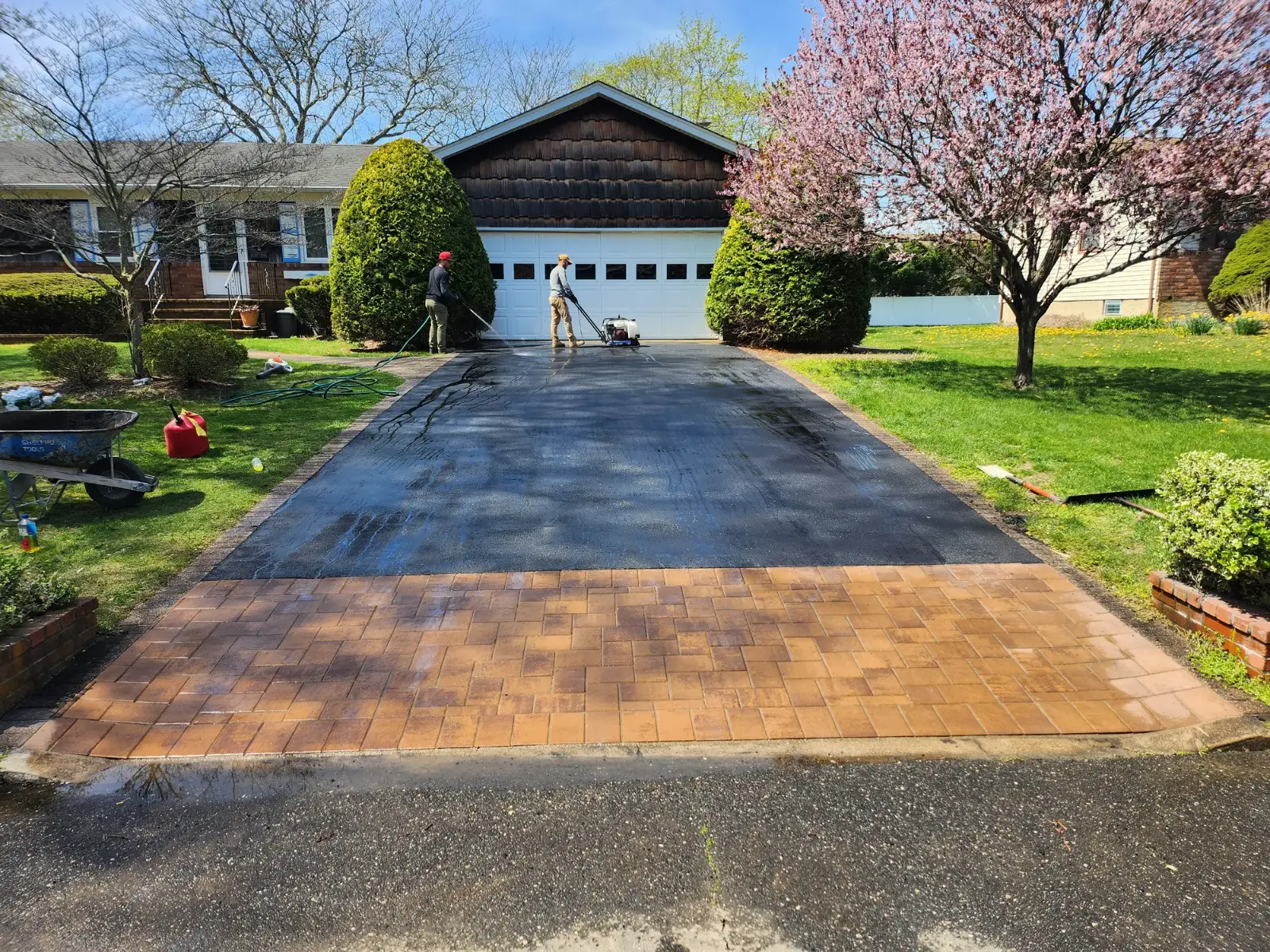 Asphalt driveway with tan paver apron by Promaster Maintenance Corp, Long Island, NY