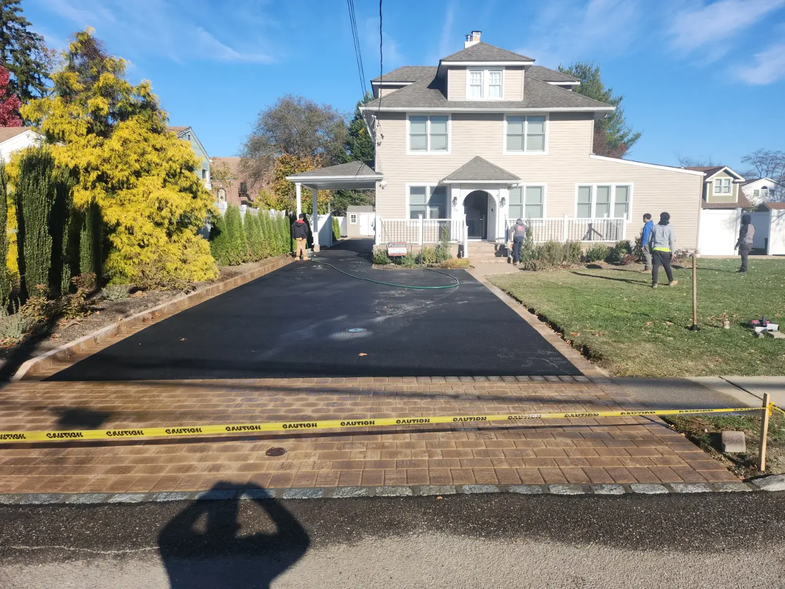 Finished asphalt driveway with paver apron by Promaster Maintenance Corp, Long Island, NY