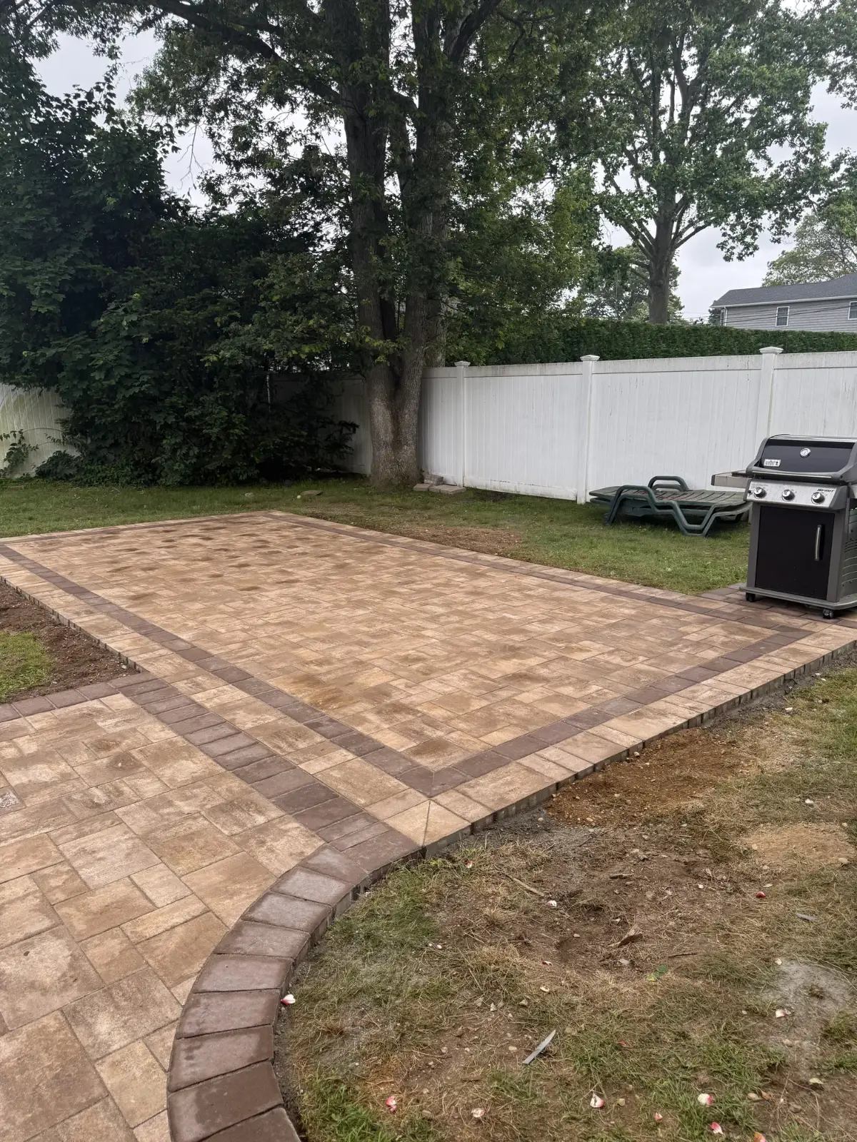 Backyard paver patio with a contrasting soldier-course border, installed by Promaster on Long Island