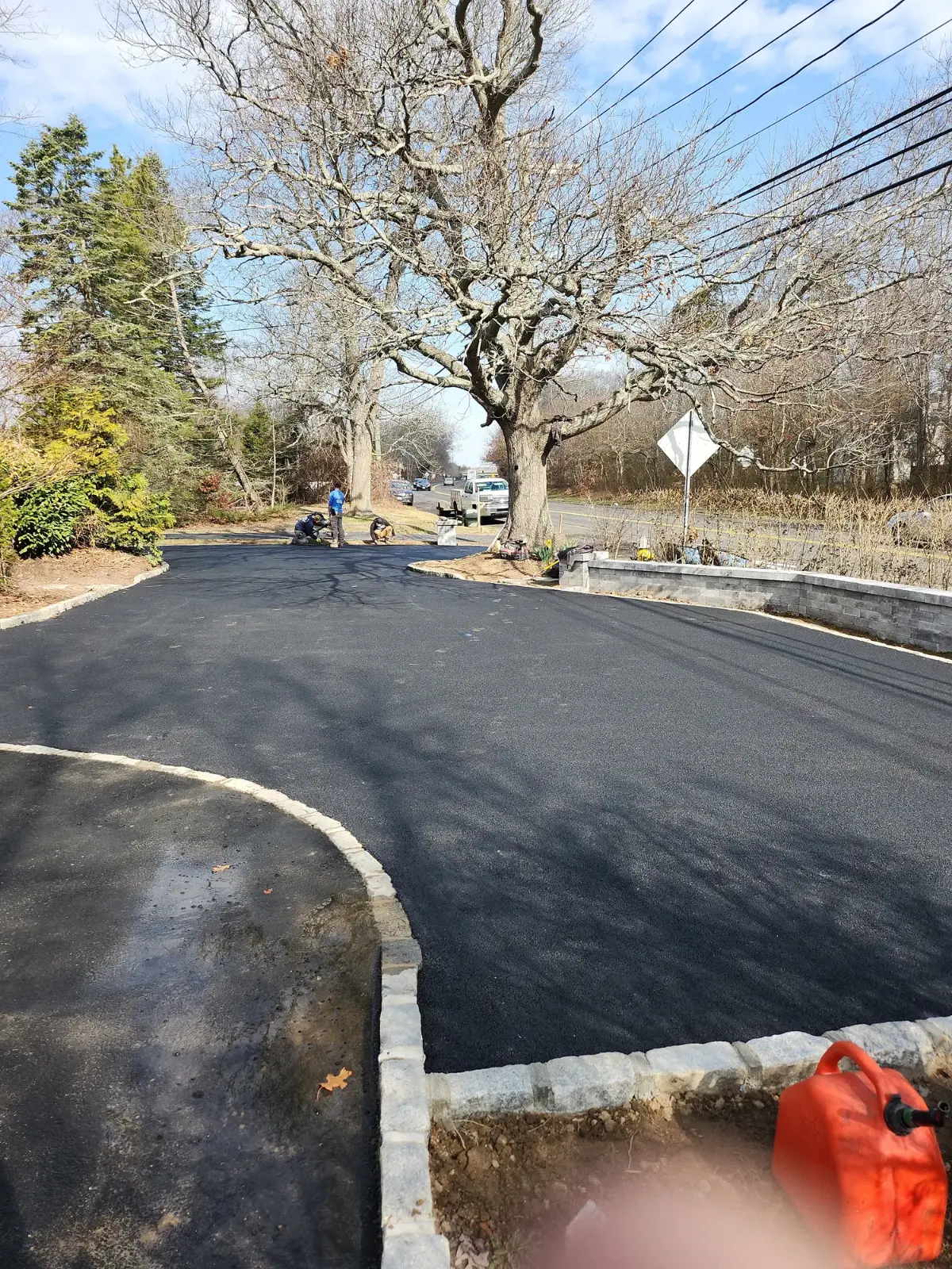 Curved asphalt driveway with Belgian block edging by Promaster Maintenance Corp, Long Island