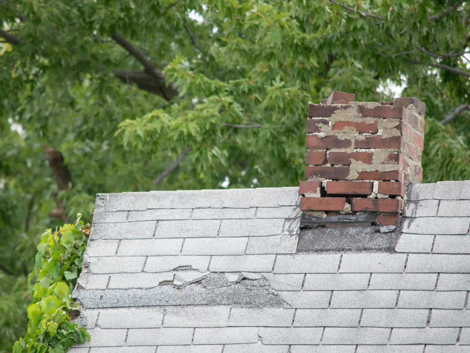 Weathered brick chimney with failing mortar
