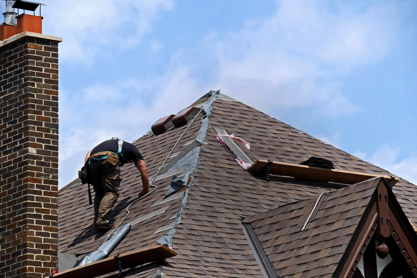 Roofer fitting ridge vents and flashing by Promaster Maintenance Corp, Long Island, NY