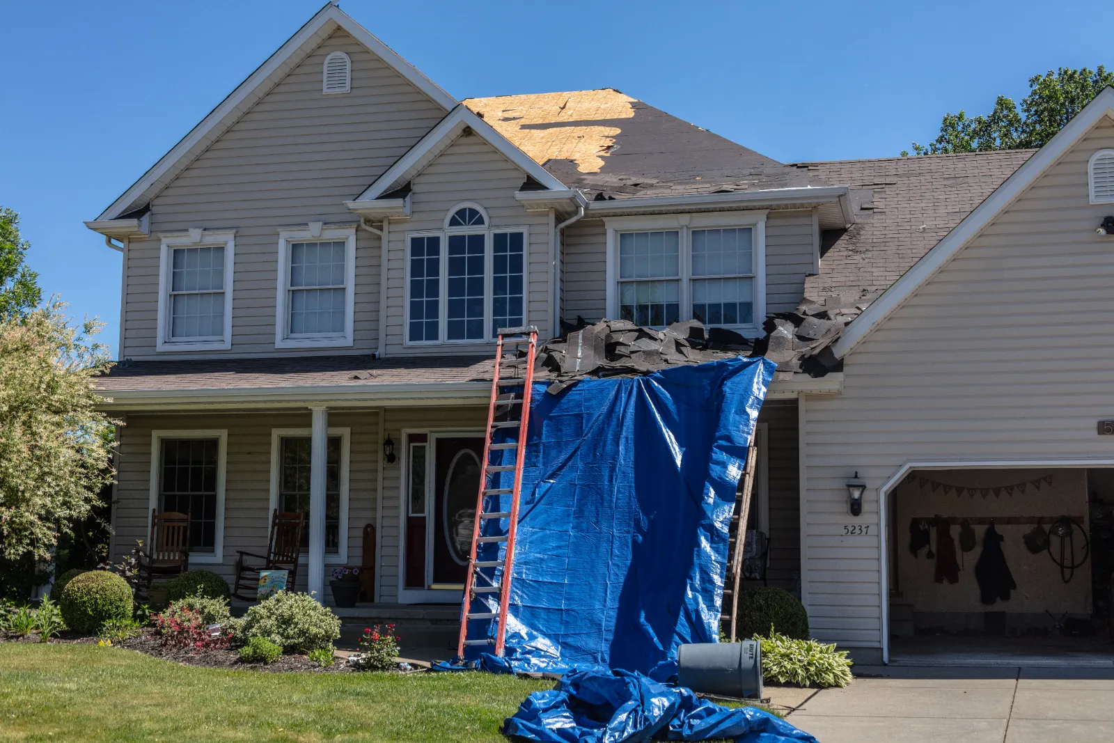 Storm-damaged shingle roof tarped for emergency repair by Promaster Maintenance Corp, Long Island, NY